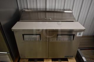 True two-door stainless steel refrigeration unit with closed lid, in sturdy condition. QR code tag on front.