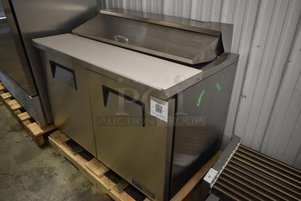 Stainless steel commercial sandwich prep table with two doors and a white cutting surface. Excellent condition, QR code label on front.