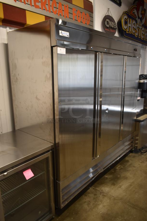 Avantco stainless steel commercial refrigerator, double-door, with visible wear marks. Features label and number tag.