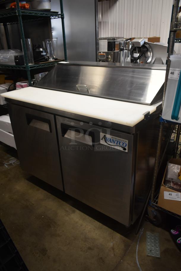 Avantco stainless steel refrigerated prep table with two doors and cutting board, in good condition for auction.