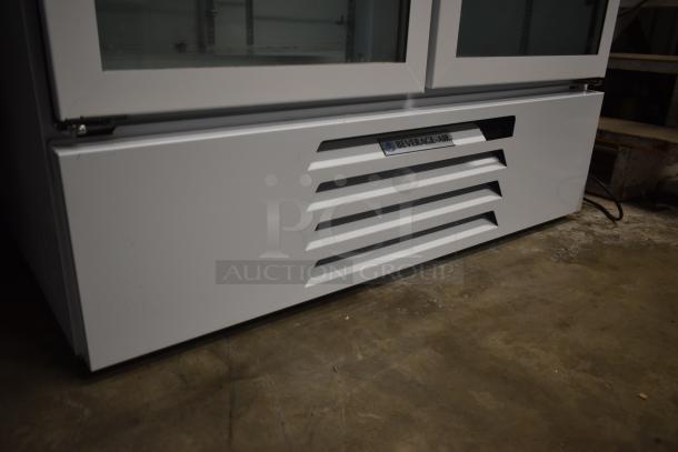 Beverage-Air commercial refrigerator, white with dual glass doors, horizontal vents, and a logo label, in used condition.