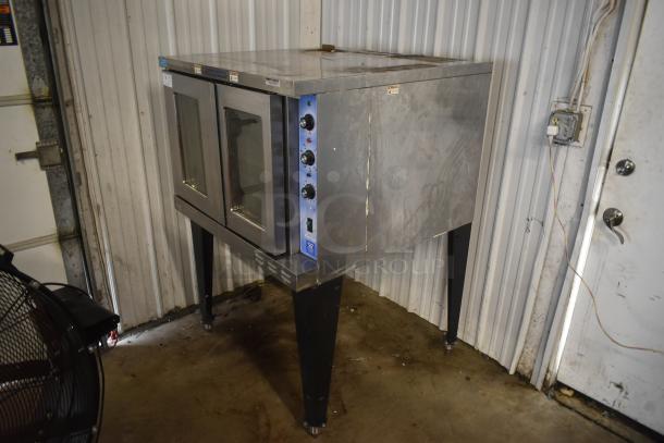 Commercial convection oven, dual glass doors, stainless steel, used condition with visible wear, control knobs intact.