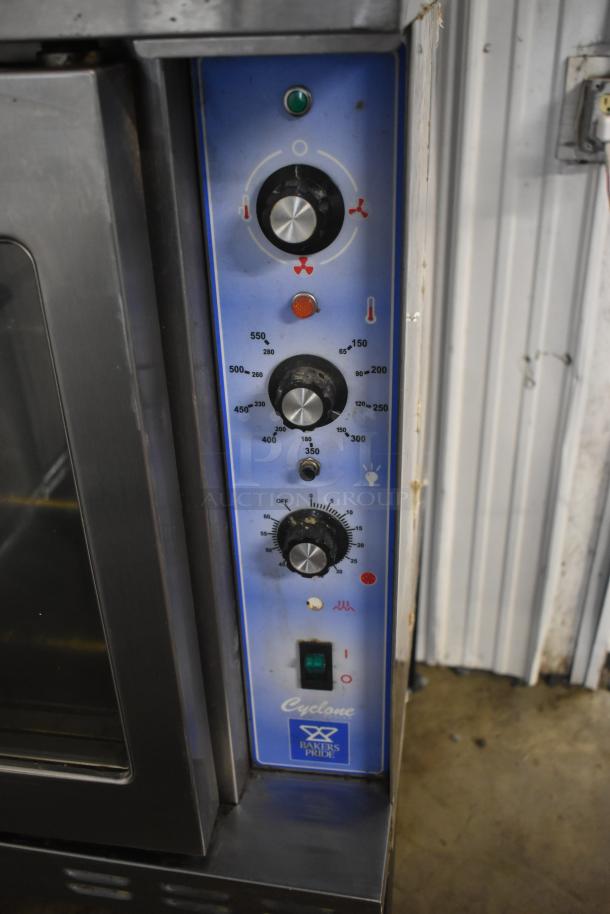 Bakers Pride Cyclone commercial oven control panel, blue with temperature and mode knobs, in used condition.