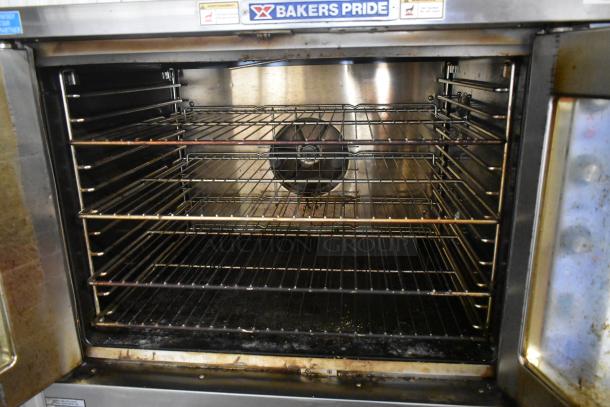 Bakers Pride commercial convection oven with multiple wire racks. Used condition, oven fan visible at back, exterior labels intact.