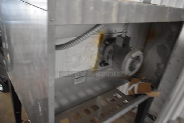Industrial metal equipment showing motor and cables, signs of wear, with visible wiring diagram and labels inside.