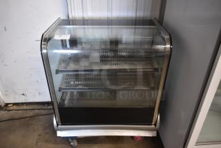 Glass-front refrigerated display case with two perforated shelves, stainless steel frame, on wheels, tag labeled "10".