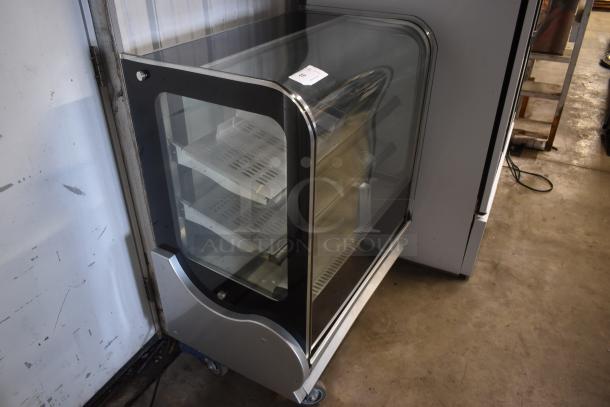 Glass display case on wheels, three shelves, black and silver metal frame, minor wear, auction tag numbered "10".
