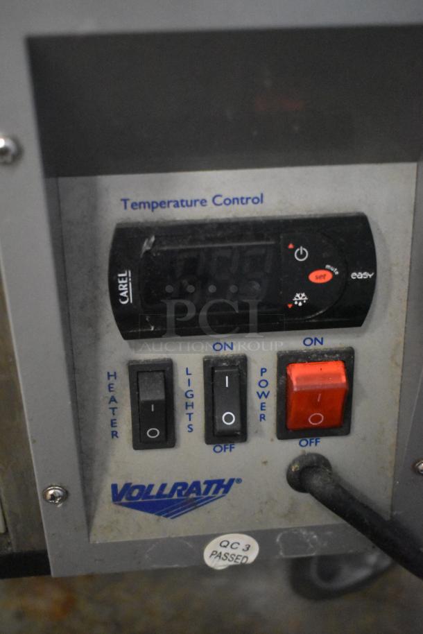 Vollrath temperature control panel with CAREL display. Features heater, lights, and power switches. QC 3 passed sticker visible.