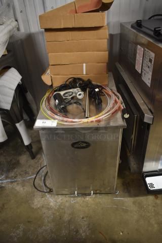 Stainless steel beverage tower with hoses and electronic pump, marked as model "Schluftz Wulf," appears in used condition.