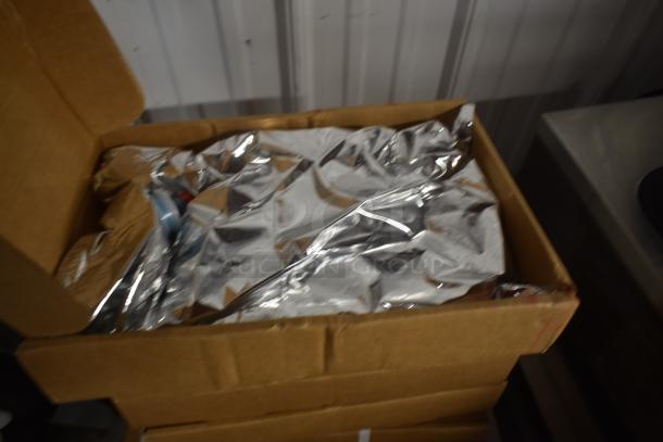 Cardboard box with reflective aluminum foil packaging inside, possibly for insulation or protection. Condition appears new.