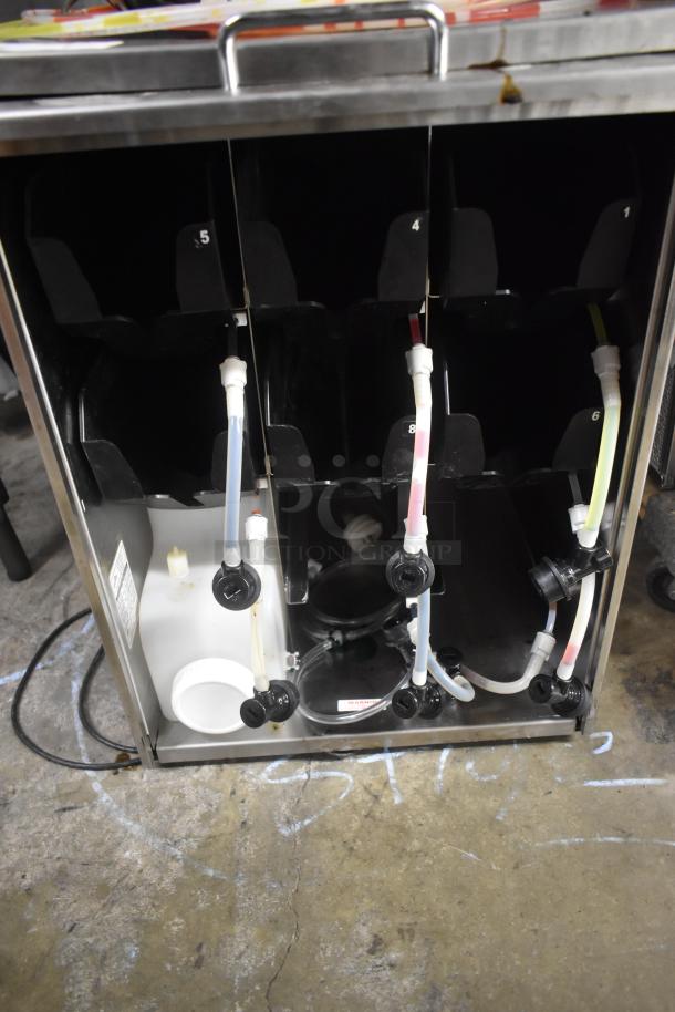 Beverage dispenser system with multiple tubes and connectors, used condition. Numbered slots and hoses for different drinks.