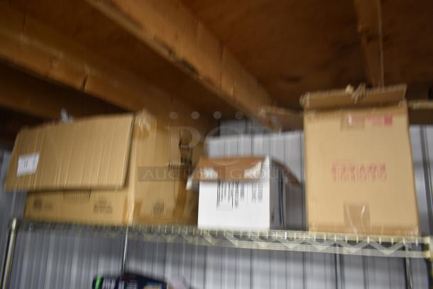 Blurred image of cardboard boxes on a metal shelf, no visible labels or markings discernible.