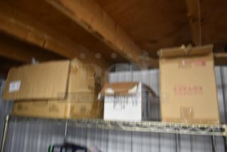 Blurred image of cardboard boxes on a metal shelf, no visible labels or markings discernible.