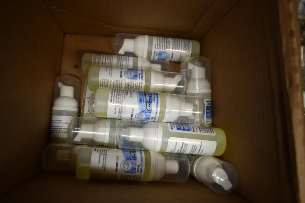 Box of foam soap dispensers with labels indicating Keystone brand, antibacterial hand soap, several bottles in new condition.