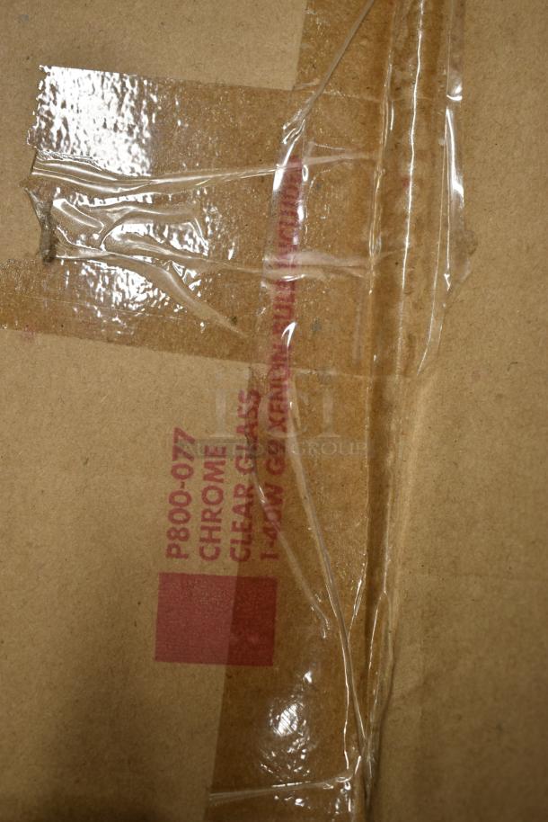 Cardboard with label "P800-077," "Chrome," and "Clear Glass," under clear tape. Possible packaging for a lighting product.