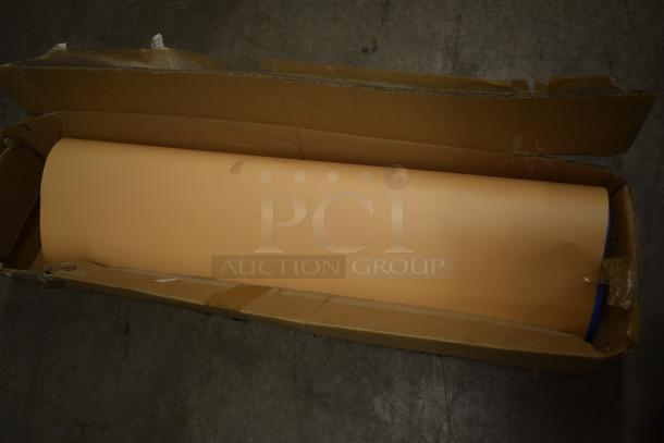Large rolled vinyl sheet in cardboard box, light tan color, slight scuff visible. Box shows signs of wear.