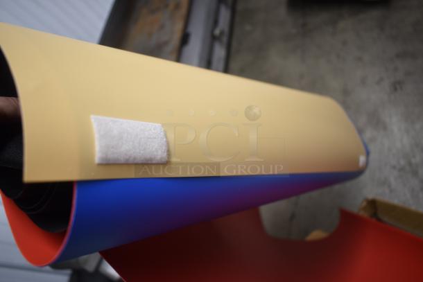 Rolled multi-color vinyl sheets with beige, blue, and red layers, featuring a white Velcro patch, in excellent condition.
