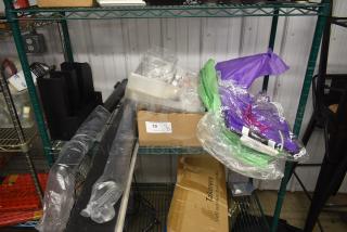 Assorted packaging supplies on shelves, including plastic wrap, cardboard boxes, and organizers. Item tag marked "19".