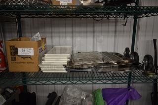 Stack of white trays, metal racks, and baking sheets on a metal shelf. Box labeled "City Electric Supply" with lot number 20.