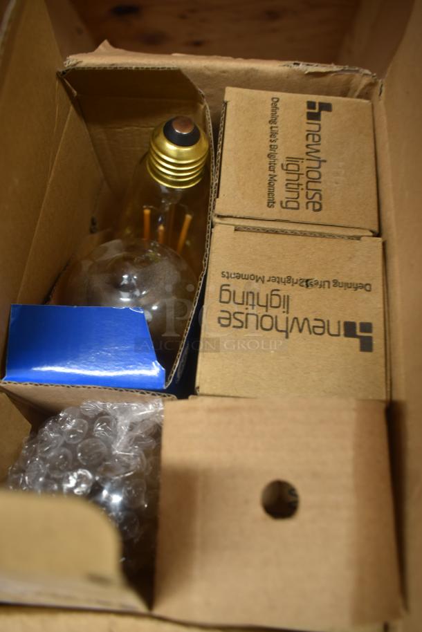 Newhouse Lighting light bulb in original packaging with protective bubble wrap, box labeled "Defining Life's Brighter Moments."
