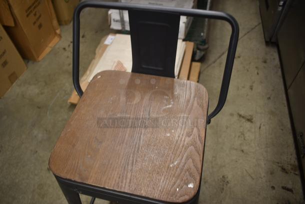 Industrial-style wooden seat with metal frame, showing minor wear. Ideal for rustic decor or seating needs. No visible labels.