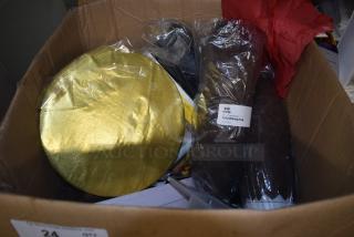 Box of assorted baking supplies, featuring a gold cake board and packages of brown tulip baking cups.