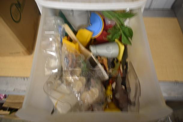 A large plastic container filled with assorted household items and toys, appearing in mixed condition.
