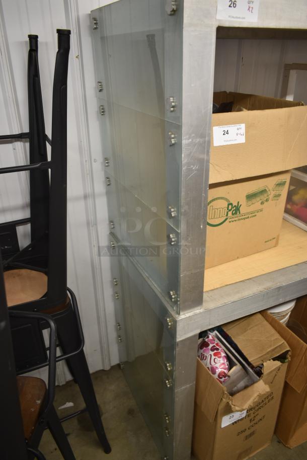 Stacked metal storage shelves with transparent panels, secured with bolts. Includes cardboard boxes and labeled "24 QTY."
