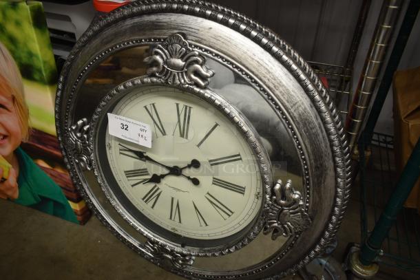 Large silver wall clock with decorative frame, Roman numerals, and vintage design. Auction tag: Lot 32, XL size, PDAuctions.com.