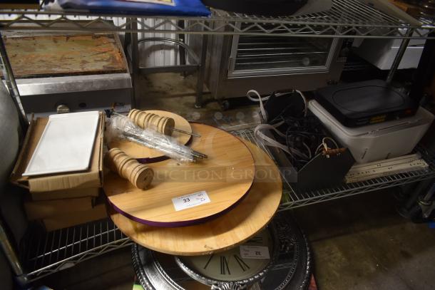 Kitchen items on a metal shelf: wooden trays, salt and pepper mills, a white serving plate, and a burner. Condition appears used.