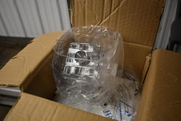 Chrome wire shelf in protective plastic, new condition, in open cardboard box with packaging material.