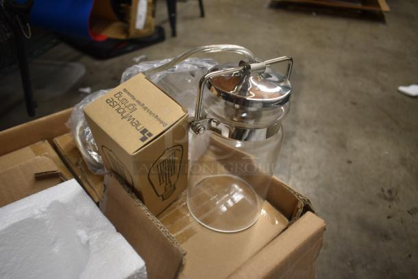 Glass jar with metal lid, in new condition, atop a cardboard box. Box labeled "Neptune House Lighting."