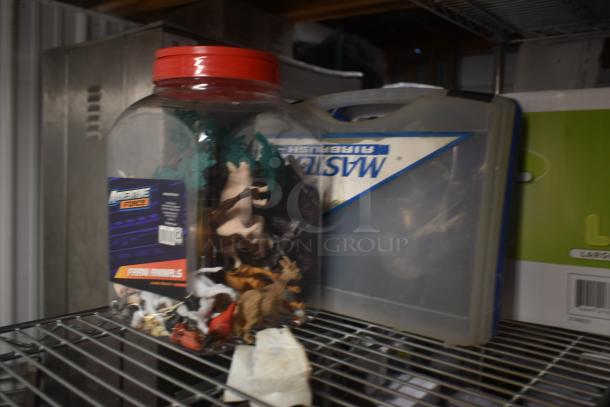 Jar of assorted farm animal figurines with red lid, label reading "Adventure Force Farm Animals," on metal shelf.