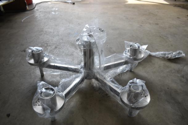Metal chair base wrapped in protective plastic, featuring a five-arm design with casters, pristine condition.