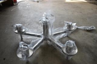 Metal chair base wrapped in protective plastic, featuring a five-arm design with casters, pristine condition.