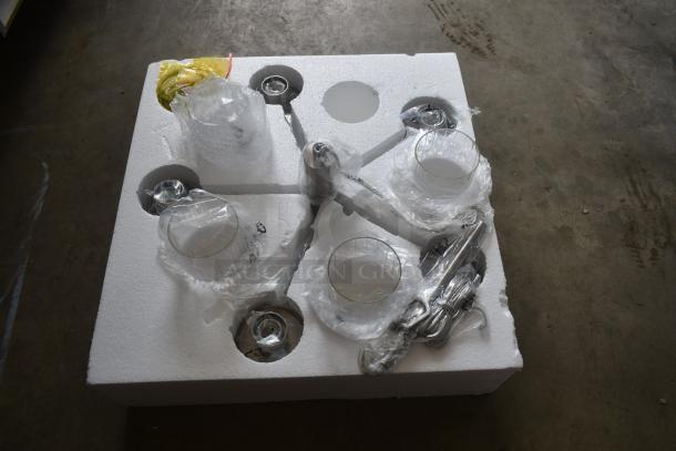 Ceiling light fixture parts in foam packaging, wrapped in plastic. Includes glass shades, metal rods. New condition.