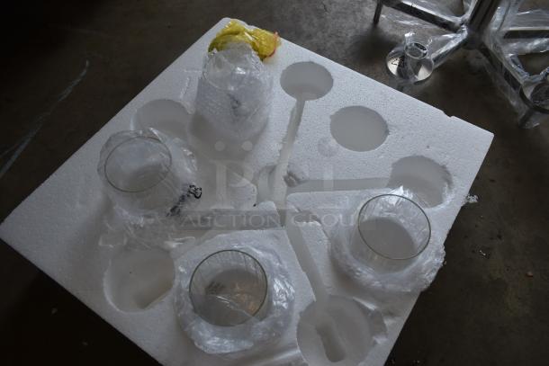 Four glass dome light shades in protective packaging on a styrofoam tray; new condition, unused.
