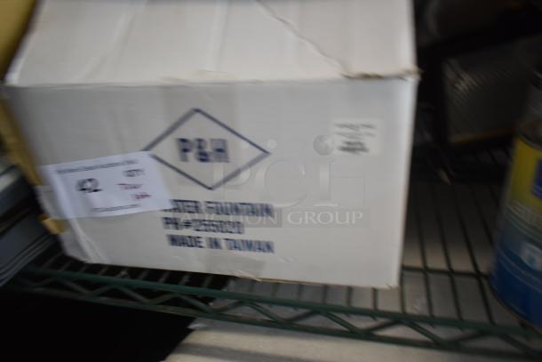 Box of P&M water fountain, model PL#2660020, made in Taiwan, appears unopened with minor box wear. Auction tag with "42."