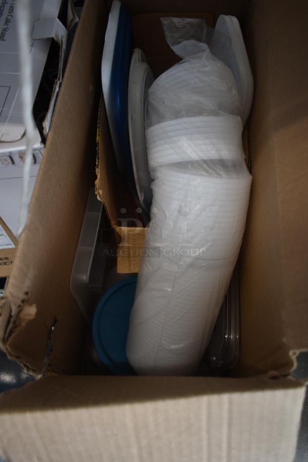 Box of assorted kitchenware, including stacked white plastic plates, lids, and various containers, in good condition.