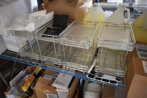 Metal storage racks with clear plastic trays, in used condition. Includes multiple compartments, ideal for organizing items.