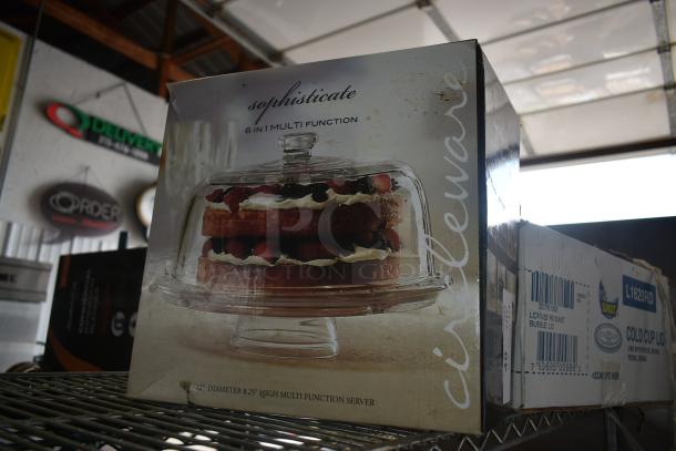 "Sophisticate 6-in-1 multi-function glass server box, 12” diameter, 8.25” high, pictured with cake inside, slight wear."