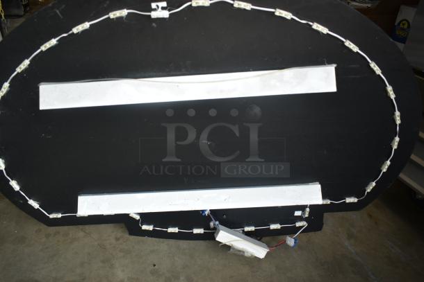 Oval-shaped sign with a black backing, surrounded by LED light strips. Includes electrical wiring and connectors, good condition.