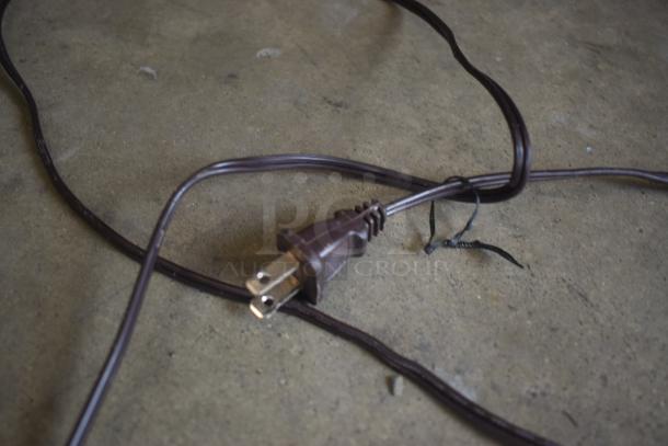 Brown electrical extension cord with a two-prong plug, frayed section, and black tie. Used condition.