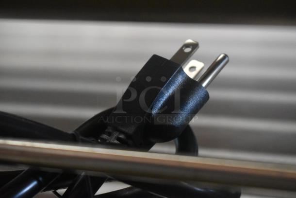 Black three-prong power plug with attached cable in excellent condition.