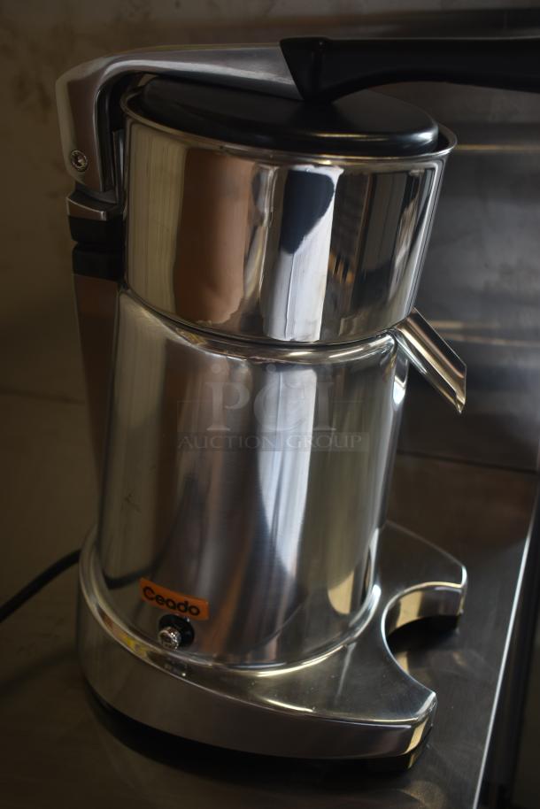 Ceado juicer in stainless steel, excellent condition, with black handle and visible logo. Compact and durable design.