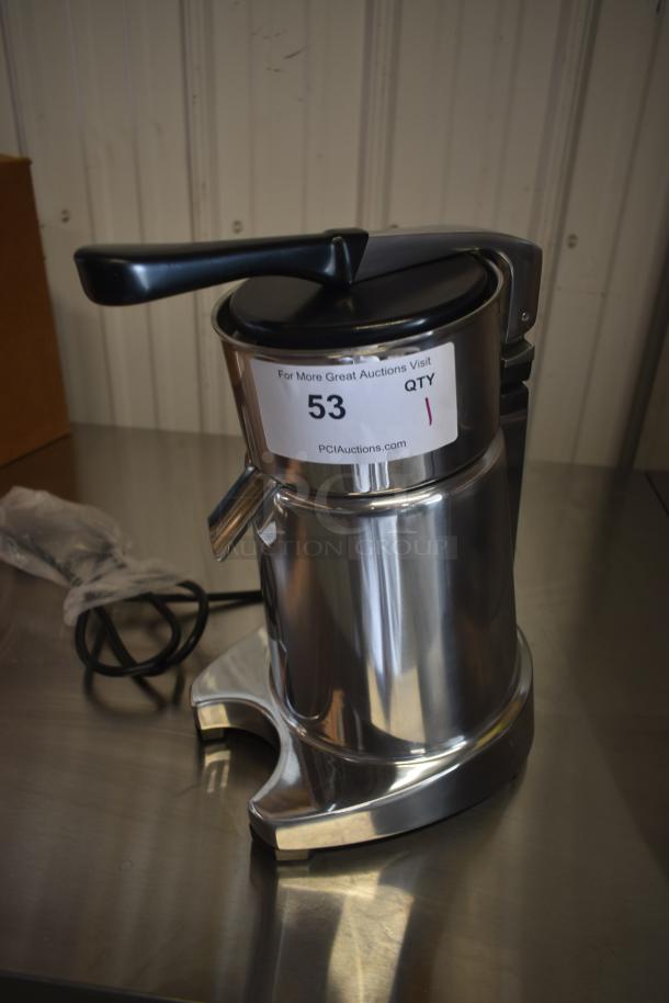 Stainless steel manual citrus juicer, model with lever handle, auction tag "53", excellent condition.