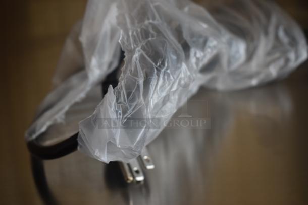 Power cord wrapped in plastic packaging, brand new condition. Three-prong plug, suitable for electronics.