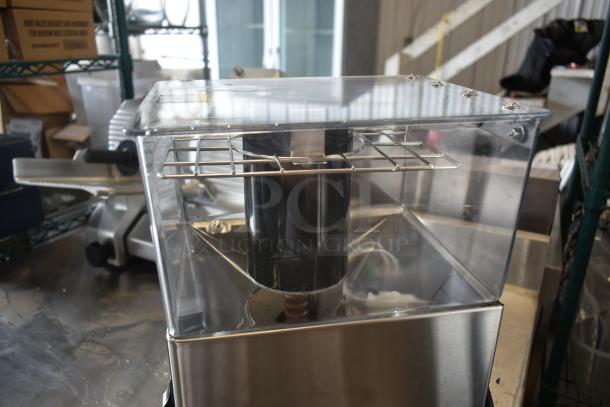 Commercial stainless steel beverage machine with transparent upper section and metal grid, in excellent condition.