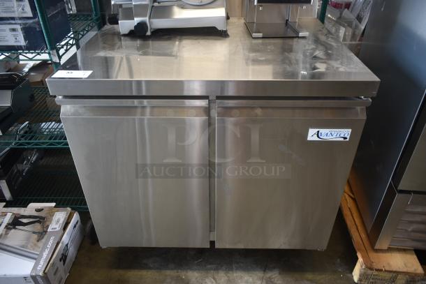 Stainless steel Avantco refrigerator, two-door, commercial use, with top-mounted slicer. Visible label: Avantco Refrigeration.