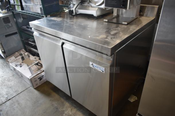 Commercial stainless steel refrigerator unit, label "Atosa". Dual door, sturdy surface, good condition, industrial use.